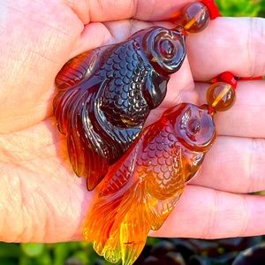 Genuine Burmese amber fish sculpture pendent with silk string in pair